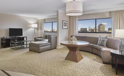 a living room with a couch and a tv at Hyatt Regency Milwaukee in Milwaukee