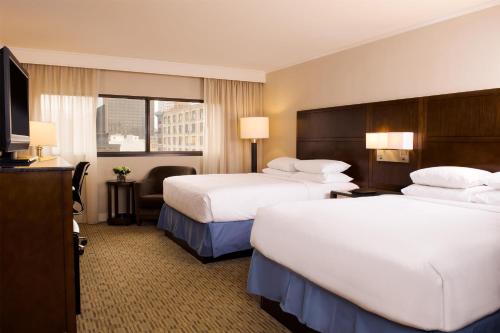 a hotel room with two beds and a television at Hyatt Regency Milwaukee in Milwaukee