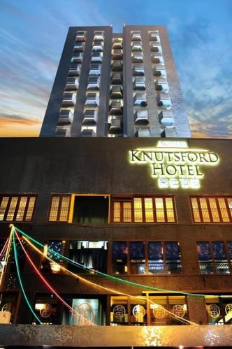 a tall building with a hotel sign on it at Acesite Knutsford Hotel in Hong Kong