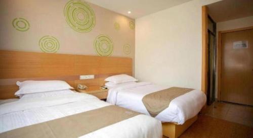 a hotel room with two beds in a room at GreenTree Inn Shanghai National Convention and Exhibition Center Huaxiang Road in Shanghai