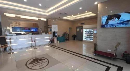 a store with a large screen in the middle of a lobby at GreenTree Inn Shanghai National Convention and Exhibition Center Huaxiang Road in Shanghai