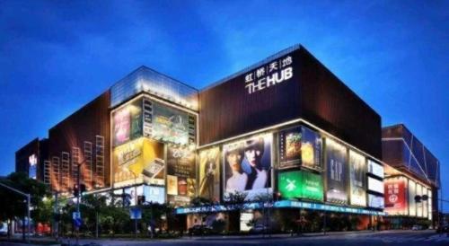 a large building with many signs on the side of it at GreenTree Inn Shanghai National Convention and Exhibition Center Huaxiang Road in Shanghai