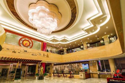 a large lobby with a chandelier in a building at New Friendship Hotel in Luoyang