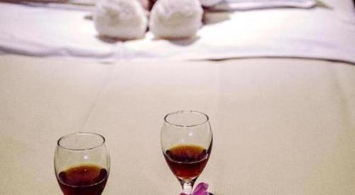 two glasses of wine sitting on a table at New Friendship Hotel in Luoyang