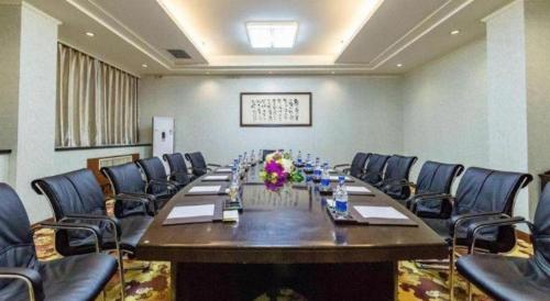 a large conference room with a long table and chairs at New Friendship Hotel in Luoyang