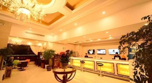 a lobby with a waiting area with people in it at GreenTree Inn Anhui Xuancheng Ningguo NinGYAng East Road Darunfa Branch in Xuanzhou