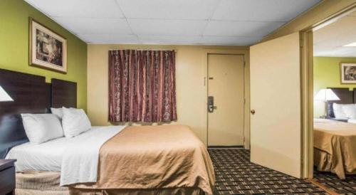 a hotel room with a large bed and a room at Rodeway Inn in Rutland