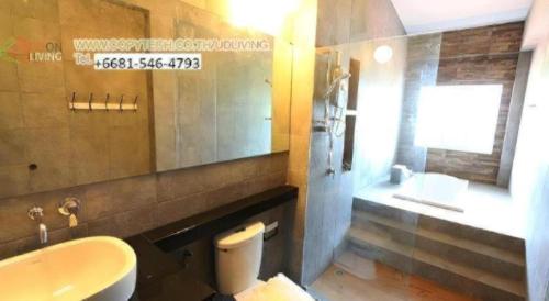 a bathroom with a toilet and a sink and a mirror at Maximize Brand New Hostel Udonthani in Udon Thani