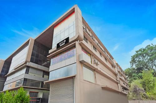 a building with a sign on the side of it at Super Hotel O Ugat Canal Surat Formerly Royal Orbit in Rānder