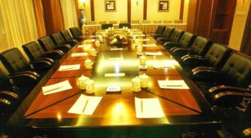 a large long table with chairs and a long table withentials at Datong Hotel in Datong