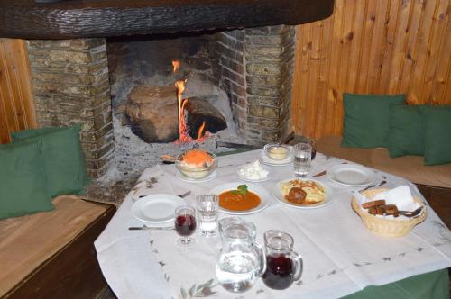 a table with food in front of a fireplace at Hotel Hani Zisi in Chania