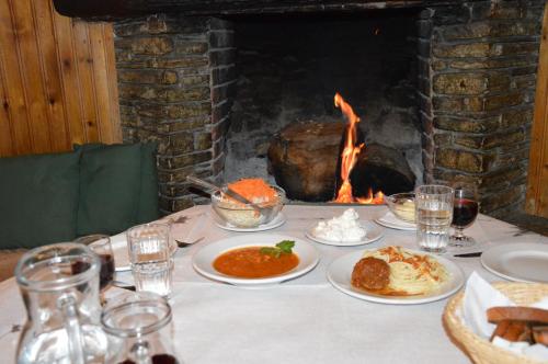 a table with plates of food in front of a fireplace at Hotel Hani Zisi in Chania