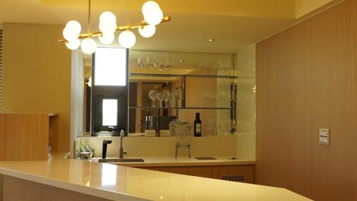 a kitchen with a counter with glasses on shelves at Auganic Hotel in Wujie