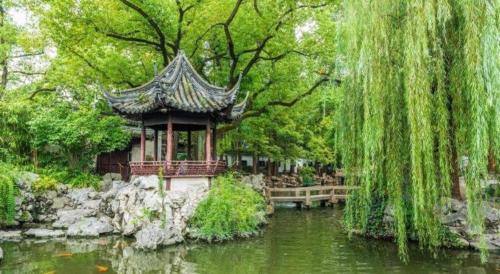 a small building next to a pond in a park at Shijia Inn On the Bund in Shanghai
