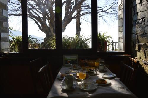 a table with food on it in a room with windows at Hotel Hani Zisi in Chania