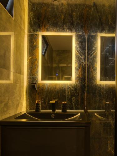 a bathroom with a sink and a mirror at Biwak Na Skarpie in Wola