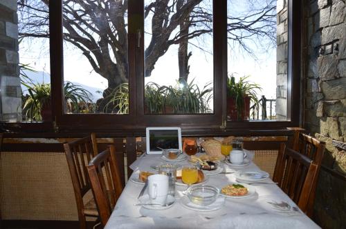 a table with food on it in a room with windows at Hotel Hani Zisi in Chania