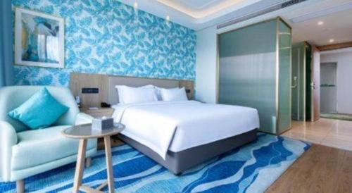 a bedroom with a white bed and a couch at Emerald Bay Hotel in Yuxi