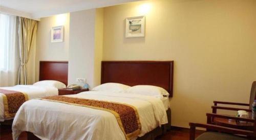 Ένα ή περισσότερα κρεβάτια σε δωμάτιο στο GreenTree Inn Nantong Haian Kaifa District Express Hotel