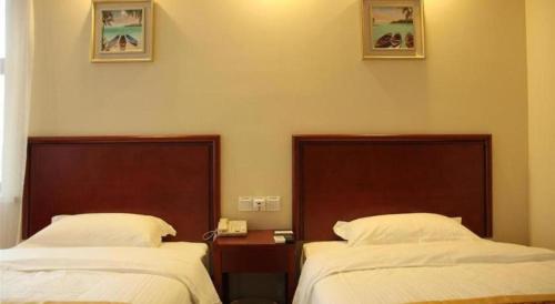 Ένα ή περισσότερα κρεβάτια σε δωμάτιο στο GreenTree Inn Nantong Haian Kaifa District Express Hotel