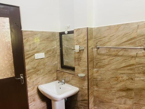 a bathroom with a sink and a glass shower at New Jaya Villa in Bentota