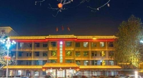 a large building with red lights in front of it at GreenTree Inn Express Hebei Shijiazhuang Zhengding County Changshan Dong Road in Shijiazhuang