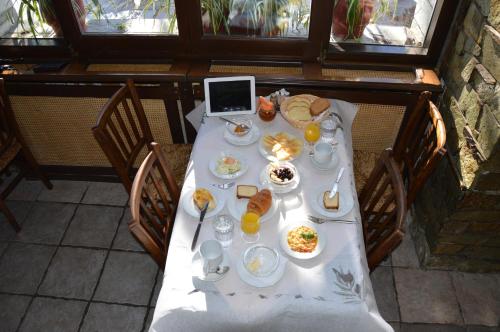 a table with breakfast food and a laptop on it at Hotel Hani Zisi in Chania