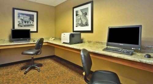 a office with a desk with a computer and two chairs at Hampton Inn Anderson in Anderson