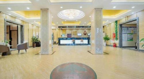 a large lobby with a large hall with pillars at GreenTree Inn Puyang Pushang Huanghe Road in Puyang