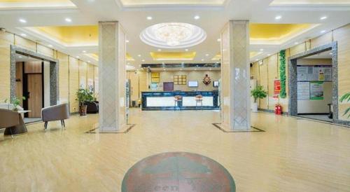 a large lobby with a large hall with pillars at GreenTree Inn Puyang Pushang Huanghe Road in Puyang