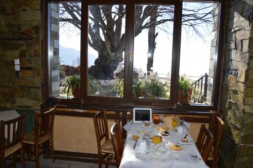 a table with food on it in a room with windows at Hotel Hani Zisi in Chania