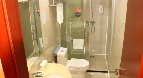 a bathroom with a shower and a toilet and a sink at GreenTree Inn Jiangsu Xuzhou Jinshan Bridge Building Jinqiao Road Express Hotel in Xuzhou