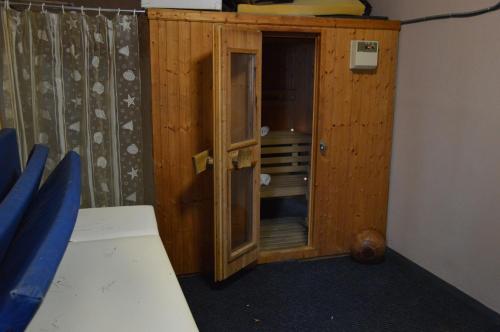 a small wooden cabinet in a room with a bed at Hotel Hani Zisi in Chania