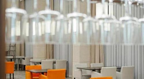 a room with tables and chairs and chandeliers at Top Cloud Hotel Iksan in Iksan
