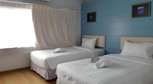 Postel nebo postele na pokoji v ubytování Cactus Resort & Hotel