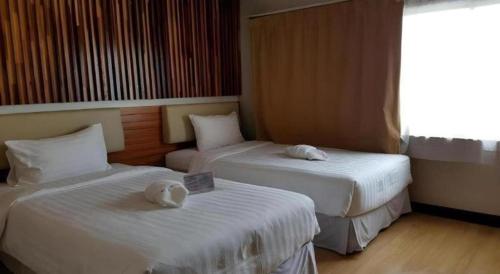 Postel nebo postele na pokoji v ubytování Cactus Resort & Hotel