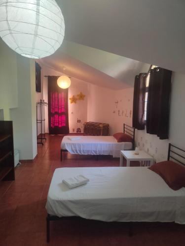 a hotel room with two beds and a light at VILLA BILBILIS con piscina privada, barbacoa y parking in Linares