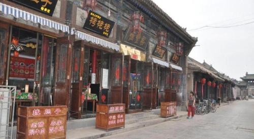 a person standing in front of a building at Pingyao Yufengheng Hotel in Pingyao