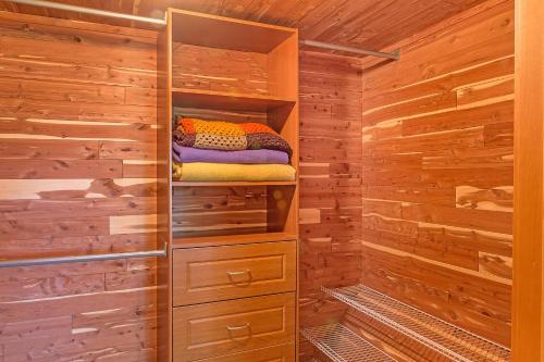a log cabin bathroom with wooden walls and a closet at The Dragonfly Cabin in Grayland
