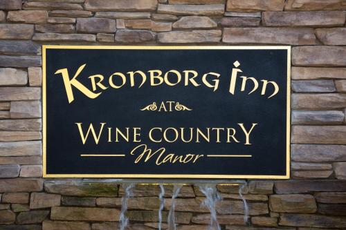 a sign for a wine country marker on a brick wall at Kronborg Inn in Solvang