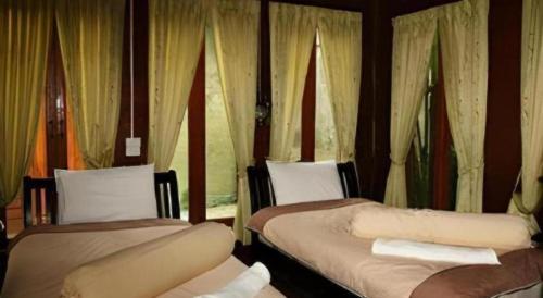 Postel nebo postele na pokoji v ubytování P&P Coffee & Resort Maesariang