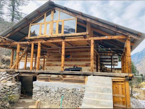 a house being built with a stone wall at Mirvana home stay in Kalgha