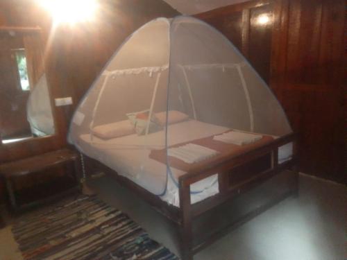 a small room with a bed in a tent at Casa Beach hut Resort in Palolem