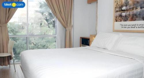 Кровать или кровати в номере An Hotel Jakarta