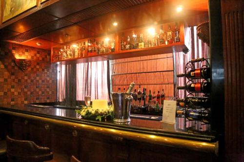 a bar with a lot of bottles of wine at Regent Park Hotel in Jalandhar
