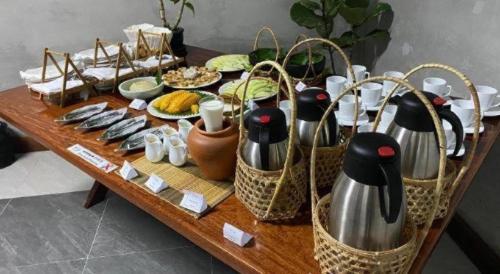 a table with baskets and plates of food on it at Asian Koh Kong Hotel in Koh Kong