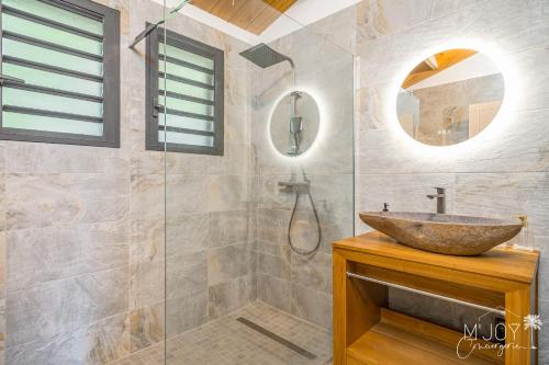 a bathroom with a sink and a glass shower at KAZ BALEN***** Villa 10 pers à St-Leu in Le Portail