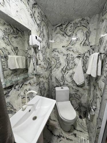 a bathroom with a toilet and a sink at Hotel 365 in Zvartnots International Airport