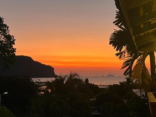 a sunset view of the ocean from a beach at Baan Taranya Koh Yao Yai Resort in Ko Yao Yai