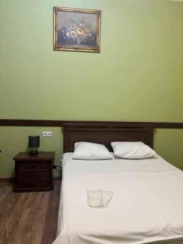 a bedroom with a bed with a picture on the wall at Hotel 365 in Zvartnots International Airport